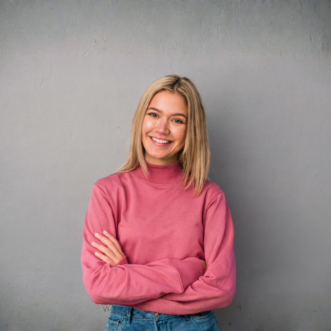 young woman smiling with her arms crossed